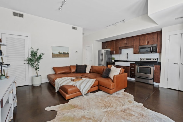 living room featuring track lighting and sink