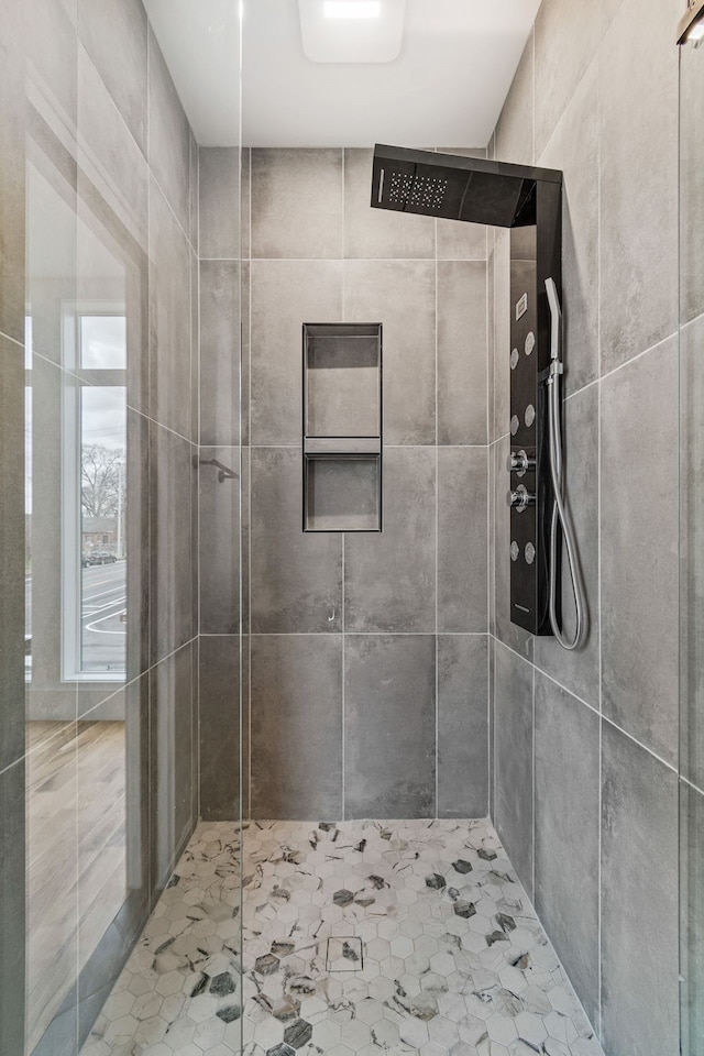 bathroom with tile walls and tiled shower