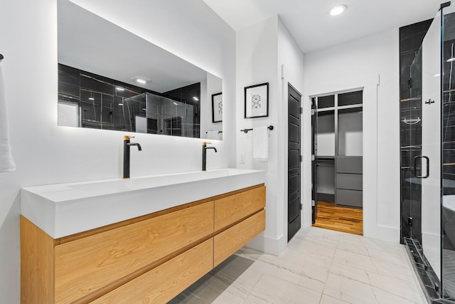 bathroom featuring vanity and an enclosed shower