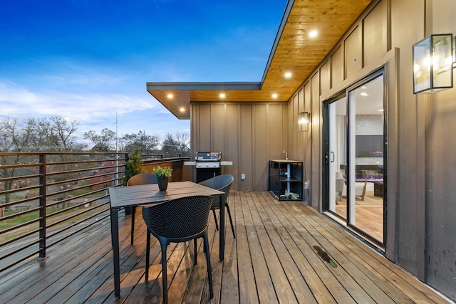 deck at dusk with grilling area