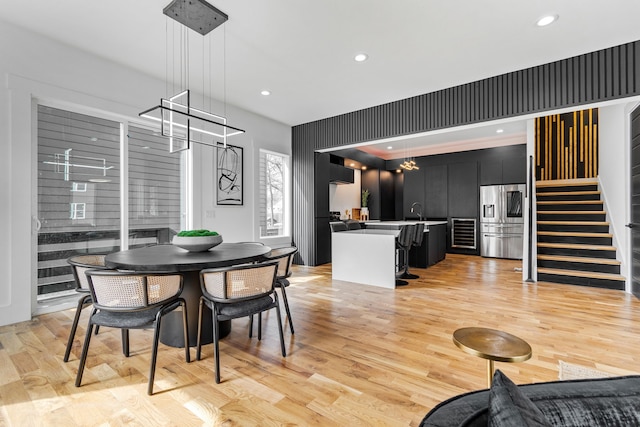 dining area featuring sink and light hardwood / wood-style flooring