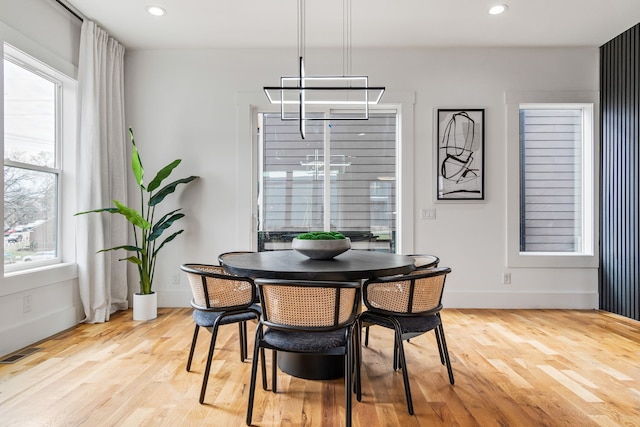 dining area featuring a notable chandelier and light hardwood / wood-style flooring