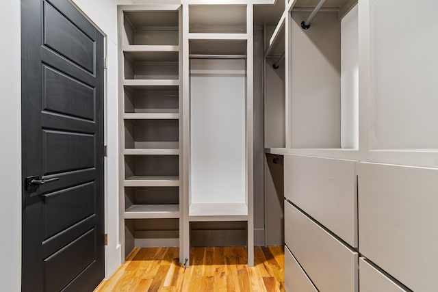 walk in closet with light wood-type flooring