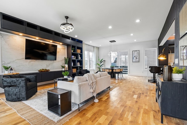 living room featuring light hardwood / wood-style flooring and a notable chandelier