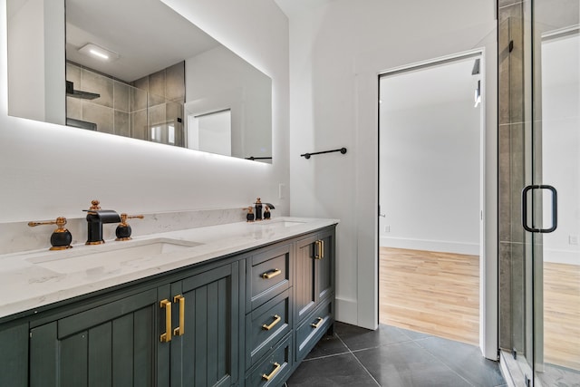 bathroom featuring a shower with door, vanity, and wood-type flooring