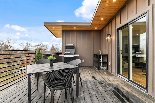 wooden deck featuring a grill