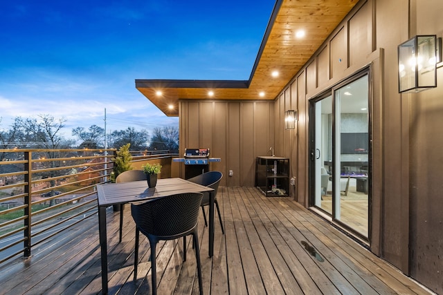 deck at dusk with area for grilling