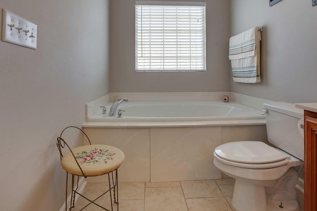 bathroom with vanity, toilet, and a tub to relax in