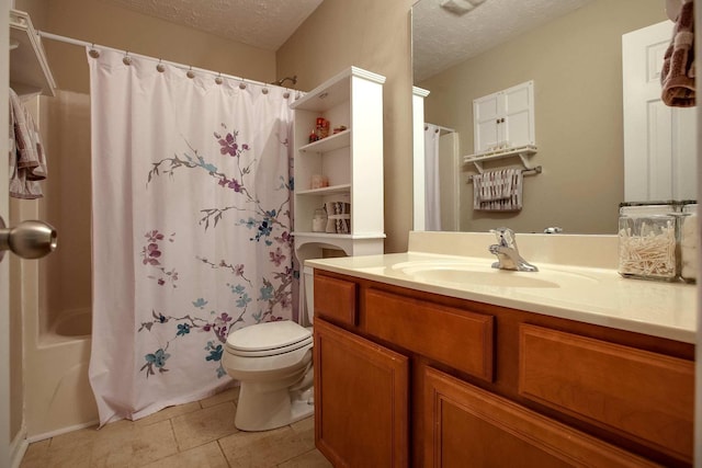 full bathroom with tile patterned floors, toilet, shower / tub combo with curtain, vanity, and a textured ceiling