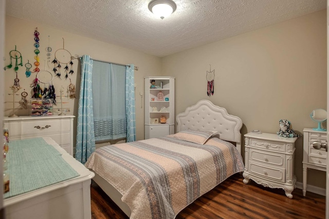 bedroom featuring dark wood-type flooring and a textured ceiling