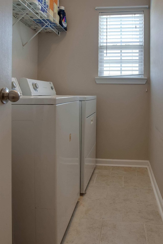 clothes washing area with washing machine and dryer