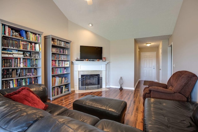 living room with dark hardwood / wood-style flooring, a fireplace, and vaulted ceiling