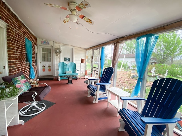 sunroom with ceiling fan and vaulted ceiling