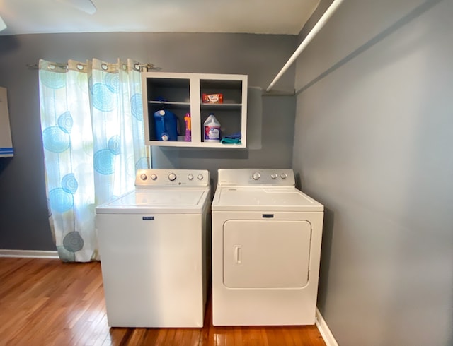 washroom with wood-type flooring and washer and dryer