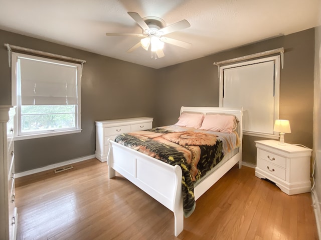 bedroom with light wood-type flooring and ceiling fan