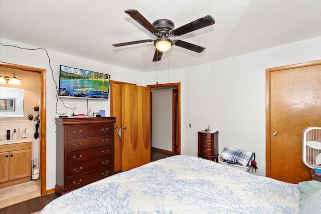 bedroom featuring connected bathroom, dark hardwood / wood-style floors, and ceiling fan