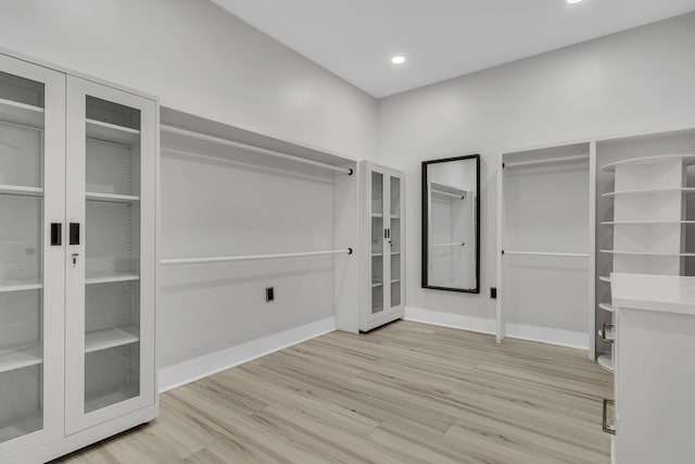 spacious closet featuring light hardwood / wood-style floors