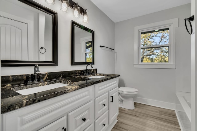 full bathroom featuring vanity, hardwood / wood-style floors, independent shower and bath, and toilet