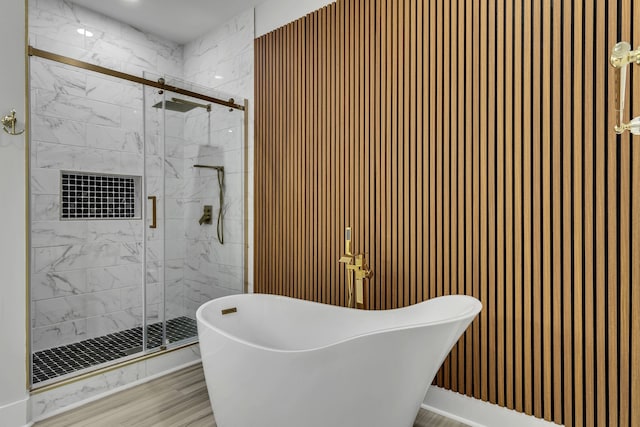 bathroom featuring hardwood / wood-style flooring and independent shower and bath