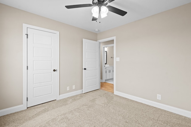 unfurnished bedroom with ceiling fan and light colored carpet