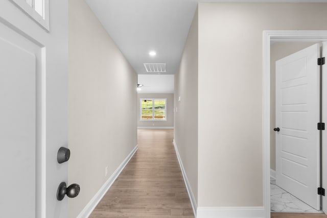 corridor featuring light hardwood / wood-style floors