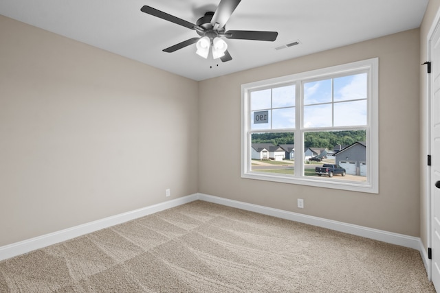 empty room with ceiling fan and carpet flooring