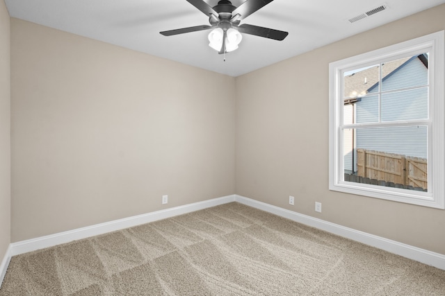 spare room with ceiling fan and carpet flooring