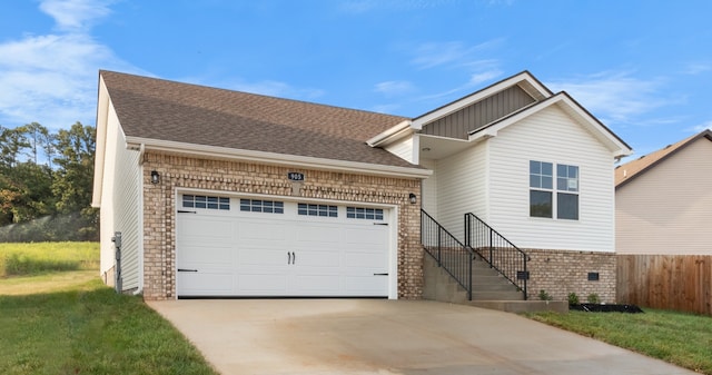 view of front of property featuring a garage and a front lawn