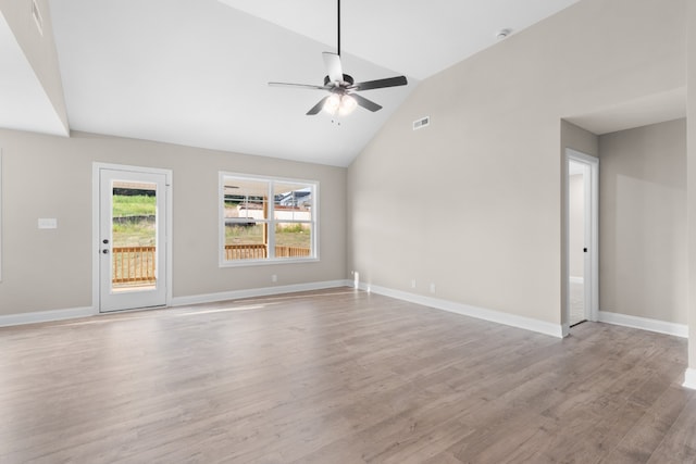 unfurnished living room with vaulted ceiling, ceiling fan, and light wood-type flooring