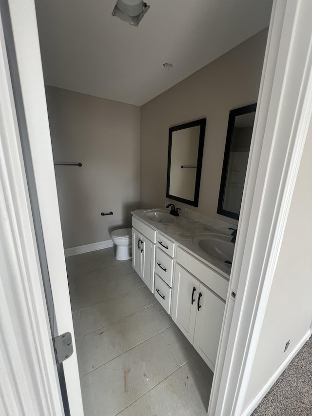 bathroom featuring vanity, tile patterned floors, and toilet