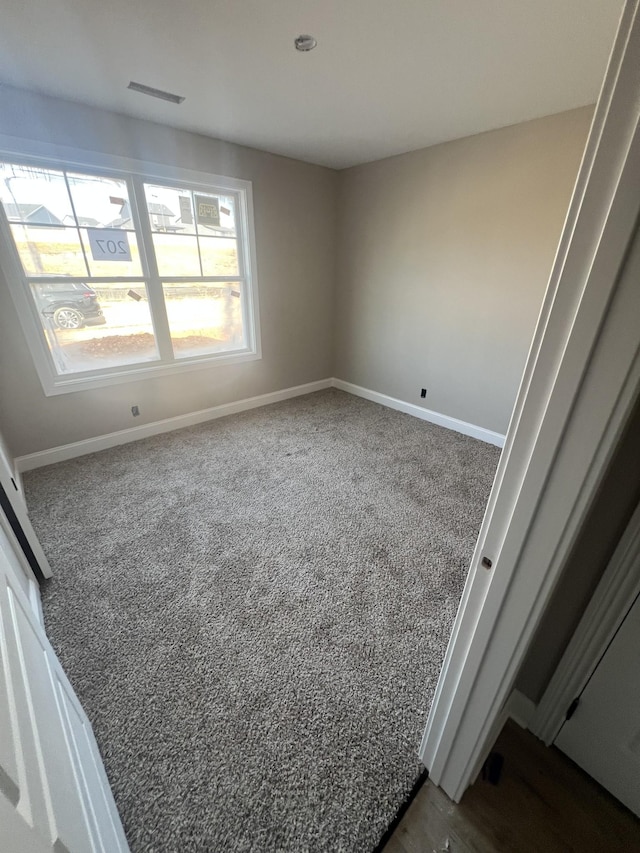 empty room with dark carpet