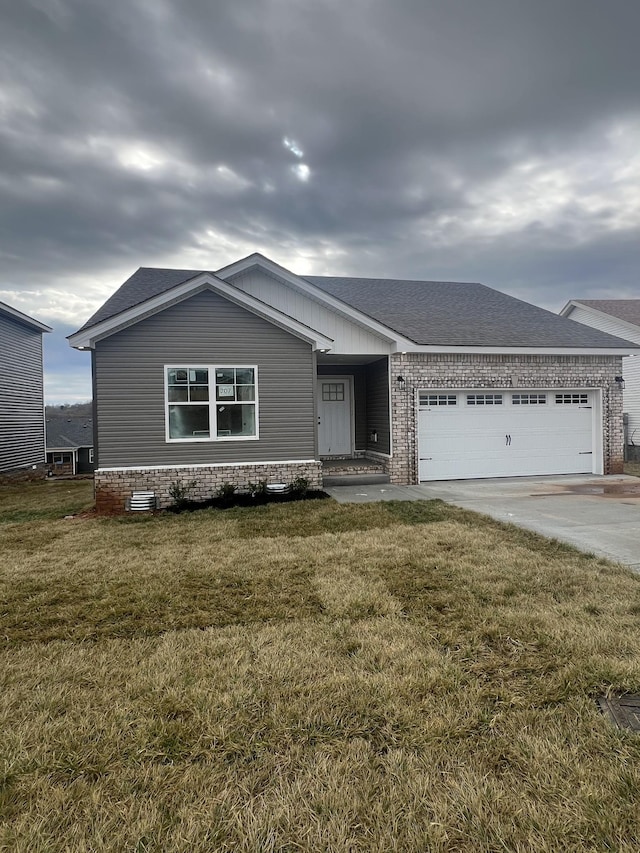 view of front of house featuring a shingled roof, concrete driveway, an attached garage, a front lawn, and brick siding