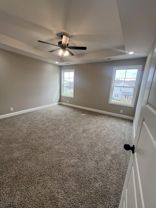 carpeted empty room featuring ceiling fan, baseboards, and recessed lighting