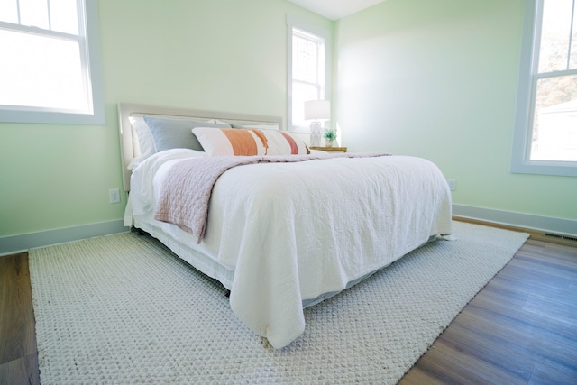 bedroom with hardwood / wood-style flooring