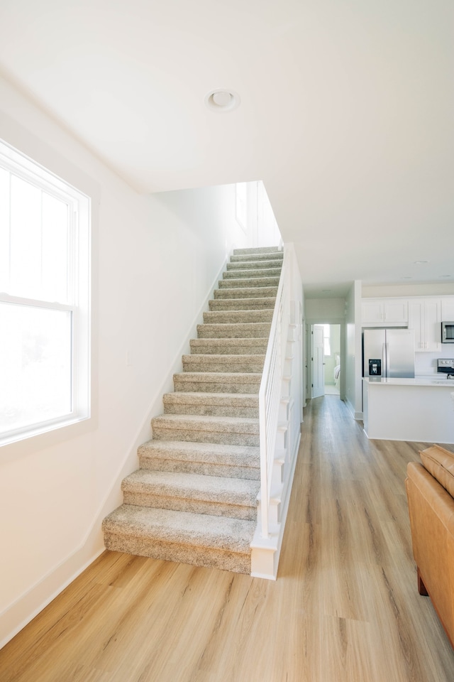 staircase with wood-type flooring