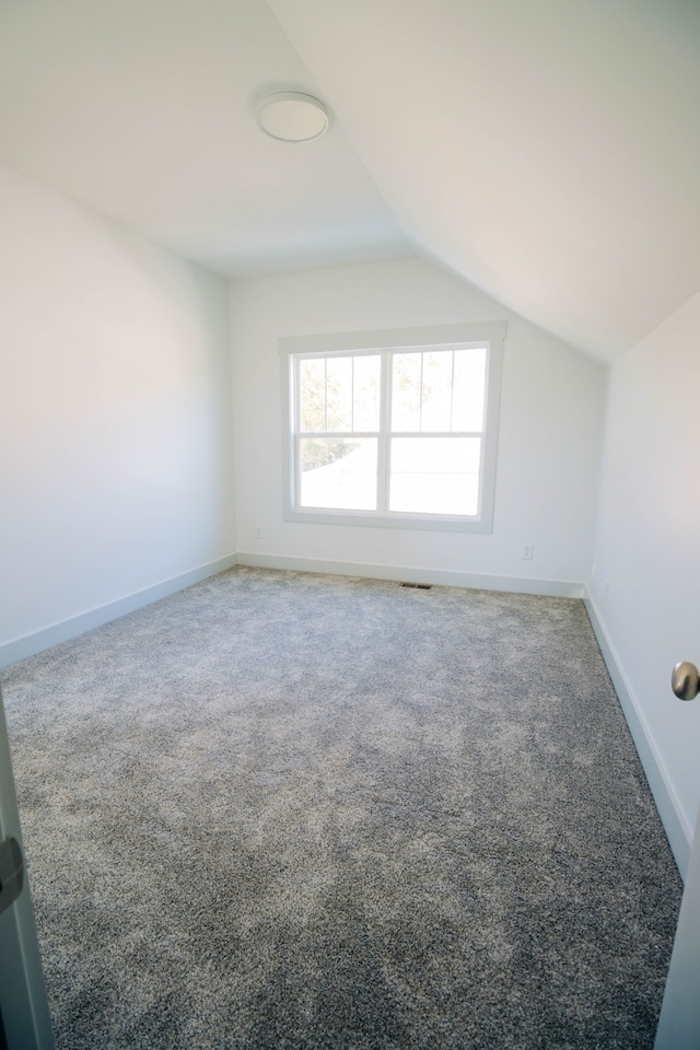 bonus room featuring carpet and vaulted ceiling