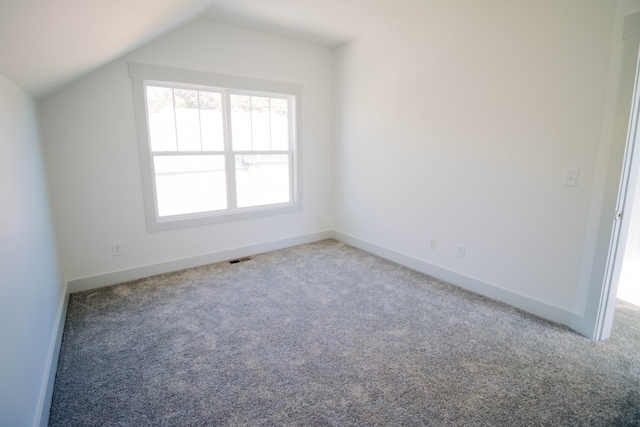 bonus room featuring carpet and vaulted ceiling