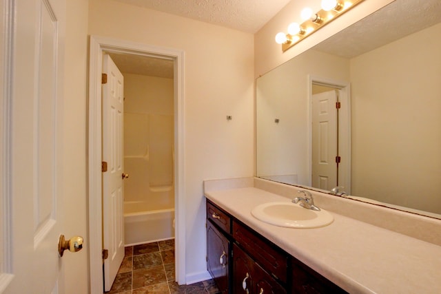 bathroom with vanity and a textured ceiling