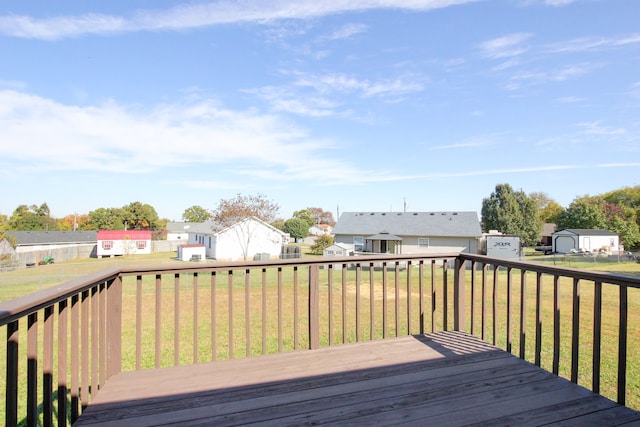 deck with a shed and a yard