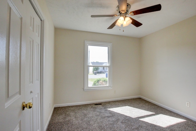 carpeted empty room with ceiling fan