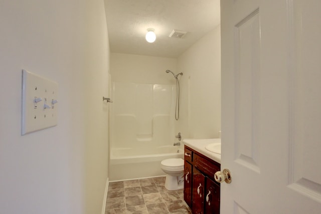 full bathroom featuring vanity, washtub / shower combination, a textured ceiling, and toilet