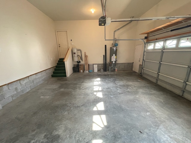 garage with a garage door opener and water heater