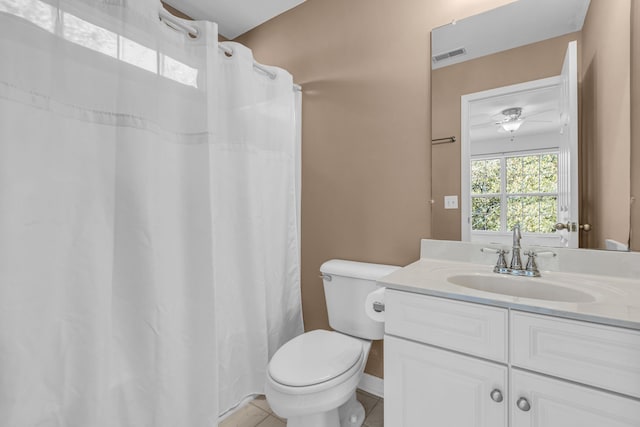 bathroom featuring toilet, tile patterned flooring, a shower with curtain, vanity, and ceiling fan