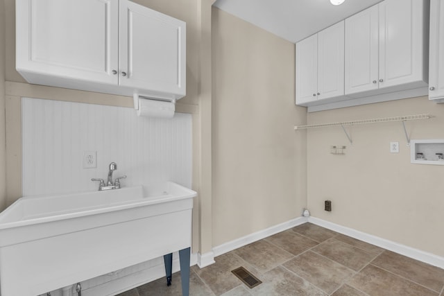 laundry area with cabinets, hookup for a washing machine, and sink