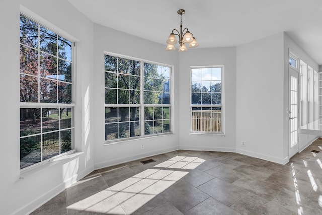 unfurnished dining area featuring a chandelier