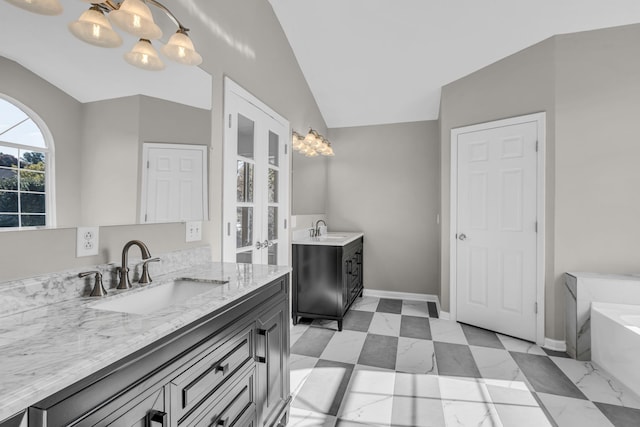 bathroom with vanity, lofted ceiling, a notable chandelier, and a bath