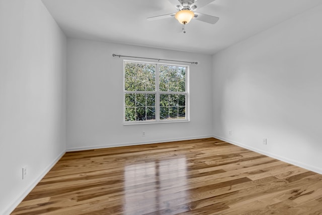 unfurnished room with hardwood / wood-style floors and ceiling fan