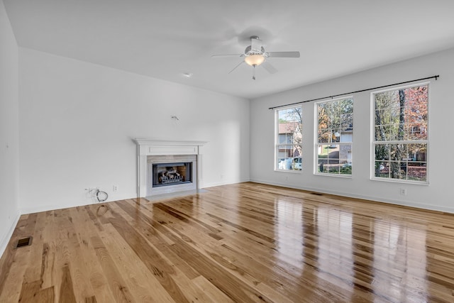 unfurnished living room featuring ceiling fan and light wood-type flooring