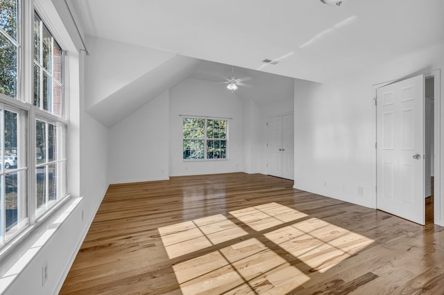 additional living space with light hardwood / wood-style floors, ceiling fan, and vaulted ceiling