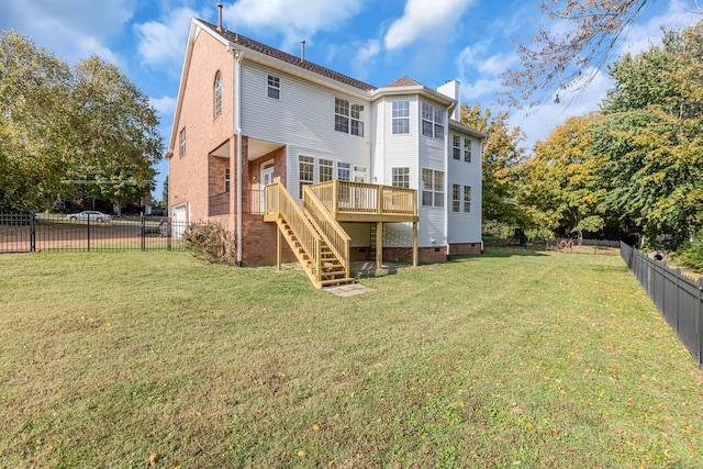 back of property with a deck and a lawn